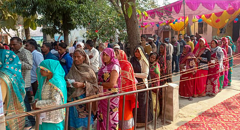 People wait to cast their votes during the Milkipur Assembly by-election, in Ayodhya district, Wednesday, Feb. 5, 2025. 