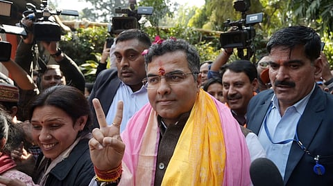 New Delhi constituency winning candidate Parvez Verma shows victory sign  at his residence in New Delhi on Saturday.