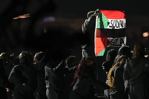 An attendee holds flags during halftime of the NFL Super Bowl 59 football game between the Kansas City Chiefs and the Philadelphia Eagles, Sunday, Feb 9, 2025 in New Orleans