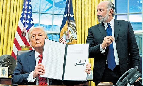 Donald Trump holds a proclamation regarding steel imports at the White House on Monday, as commerce secretary nominee Howard Lutnick watches.