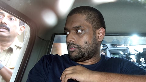 Police accompany Ananthu Krishnan, the accused in the half-price scam, to Ashoka Flats near the High Court in Kochi for evidence collection on Sunday. 