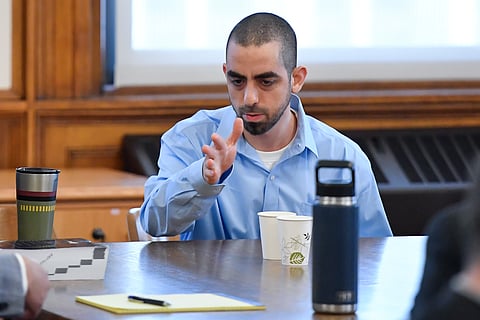 Hadi Matar, right, charged with severely injuring author Salman Rushdie in a 2022 knife attack, speaks to his defense team in Chautauqua County court in Mayville, N.Y., Monday, Feb. 10, 2025. 