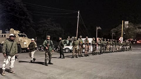 Security personnel stand guard following imposition of President's rule in the state, in Imphal East, Manipur.