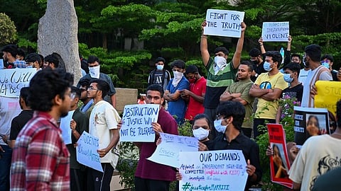 Students sit in silent protest outside the KIIT University campus demanding justice for the Nepali girl who allegedly died by suicide.