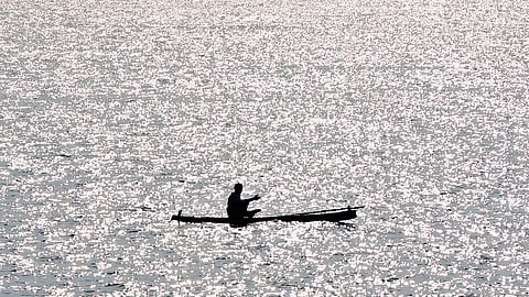 A fisherman sets out to the sea under the scorching midday sun at Vizhinjam in Thiruvananthapuram 