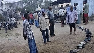 Unable to stand for a long time, farmers placed their footwear in a queue line for urea bags at Chigurumamidi mandal in Karimnagar district