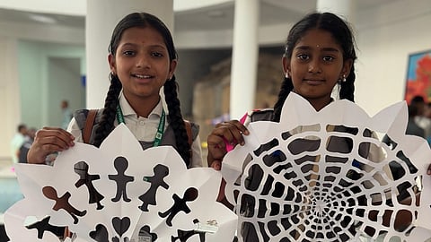 Happy students show off the artwork they made at a hands-on session at the gallery