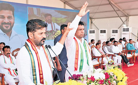 Chief Minister A Revanth Reddy raises the hand of Congress candidate in graduates’ constituency MLC election Narender Reddy during a public 
meeting in Karimnagar on Monday
