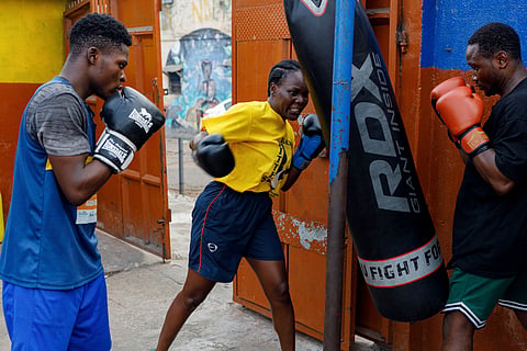 Abigail Kwartekaa Quartey, center, and other boxers train in a school compound in the Jamestown district in Accra, Ghana, Wednesday, Jan 22, 2025.