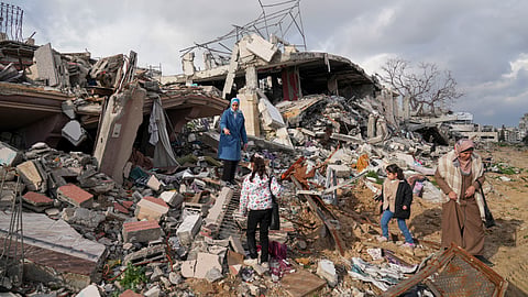 Members of the Dwaima family stand on the rubble of their home, which was levelled by an Israeli airstrike during the Israel-Hamas war, in the Tal al Hawa neighbourhood in Gaza City, Monday, Feb. 24, 2025.