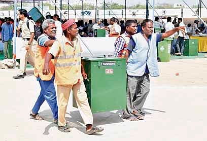 Election staff shift 
poll material from the Ambedkar Stadium in Karimnagar