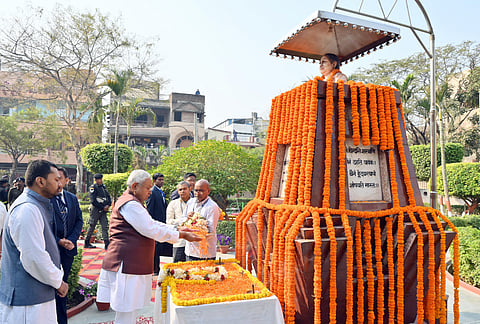  Bihar Chief Minister Nitish Kumar pays floral tributes to his late wife Manju Sinha on her birth anniversary, in Patna on Tuesday. His son Nishant Kumar is also seen. 