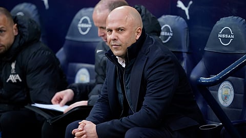 Liverpool's manager Arne Slot sits on the bench before the English Premier League soccer match between Manchester City and Liverpool at Etihad Stadium in Manchester, England, Sunday, Feb. 23, 2025. 
