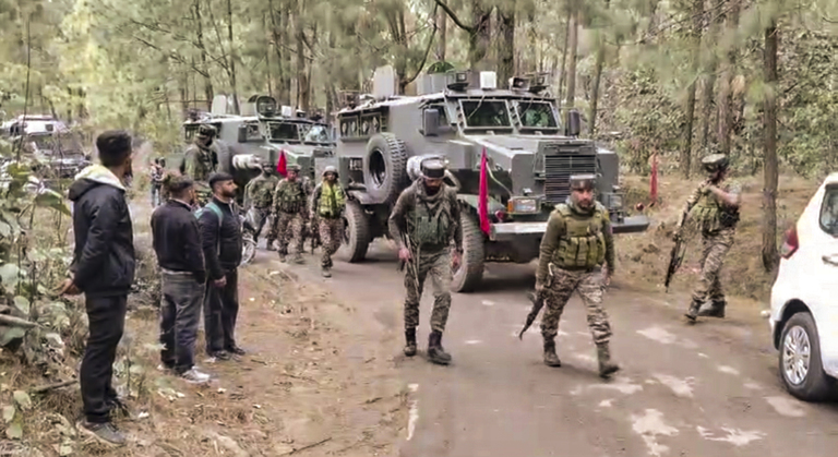 Security personnel during a search operation after an army vehicle came under fire from suspected terrorists.