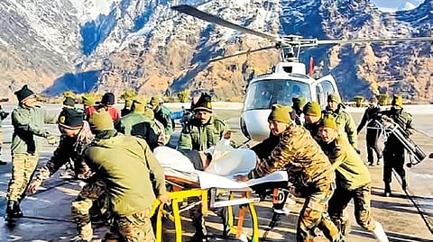 Army personnel transport workers who were safely evacuated on Saturday in Mana, Chamoli.