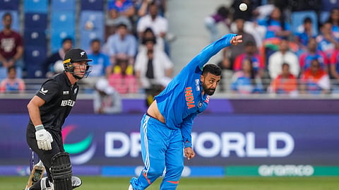 India's Varun Chakravarthy bowls a delivery during the ICC Champions Trophy cricket match between India and New Zealand, in Dubai, UAE, Sunday, March 2, 2025. 