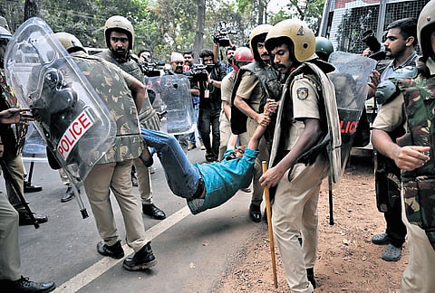 Police detain a Youth Congress worker protesting against permitting Shahabaz murder case accused to write exams at Vellimadukunnu 