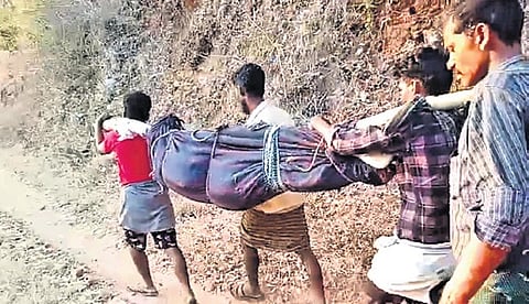 Tribal men carry a dead body in a doli as an ambulance driver refused to go further on the damaged road 