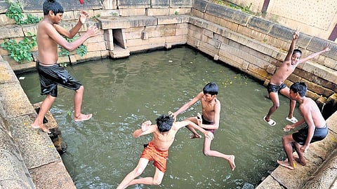 A group of boys beat the heat by taking a dip in a pond near Mariamman Teppakulam in Madurai.