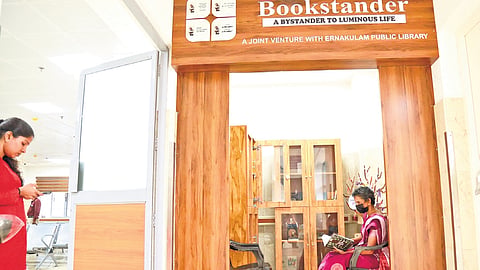 An elderly woman indulged in reading at the Bookstander set up in the oncology ward of the Ernakulam General Hospital