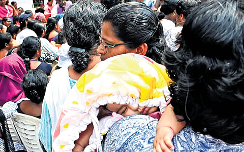 One of the women who joined the ASHA workers’ protest carries her baby along. The protest in front of the secretariat entered its 27th day on Saturday