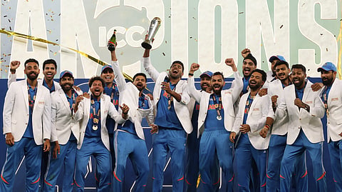 Indian players celebrate with the winners trophy on the podium after defeating New Zealand in the final cricket match of the ICC Champions Trophy at Dubai International Cricket Stadium in Dubai, United Arab Emirates.