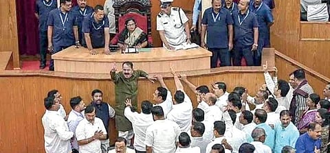 A screen grab of Congress MLA Tara Prasad Bahinipati attempting to climb the Speakers podium in the Assembly