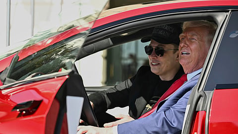 President Donald Trump and Tesla CEO Elon Musk speak to reporters as they sit in a red Model S Tesla vehicle on the South Lawn of the White House Tuesday, March 11, 2025, in Washington.