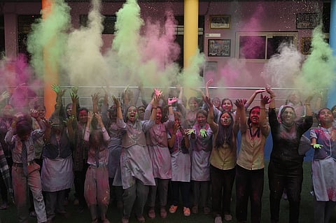 Vidya Bal Bhawan students playing holi with color ahead of Holi Festival in New Delhi on Wednesday. 