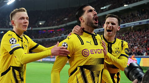 Borussia Dortmund's German midfielder #23 Emre Can celebrates with teammates after he scored his team's first goal during the UEFA Champions League last 16, second leg football match between OSC Lille and Borussia Dortmund at the Pierre Mauroy stadium in Lille, northern France, on March 12, 2025. 