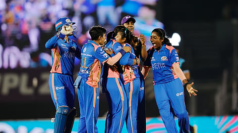 Mumbai Indians' players celebrate a wicket in the WPL final on Saturday