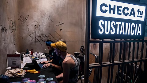 A man waits for his drug's lab results at the Check Your Substance booth that offers free drug testing, where people can confirm their drug does not contain adulterants or fentanyl, at a three-day electronic music festival in Mexico City, late Friday, Jan. 30, 2025. 