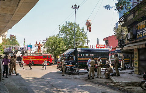 Police personnel keep a vigil at Chitnis Park area amid curfew after violence erupted on Monday night, in Nagpur, Tuesday, March 18, 2025. 