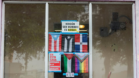 A sign in Spanish that reads, "No human being is illegal," adorns a window in Barrio Obrero, San Juan, Puerto Rico, Friday, March 14, 2025. 