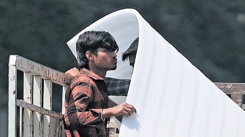 Workers shield themselves from the sun in Hitec City.