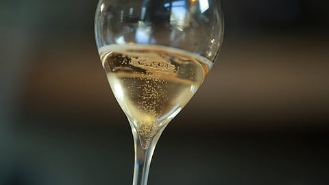 A glass of champagne is seen at the wine-making facility of wine grower David Levasseur in Cuchery, eastern France, Monday, March 17, 2025. 