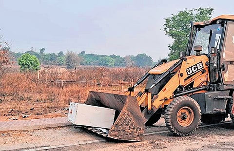 The JCB machine and ATM left behind by miscreants.