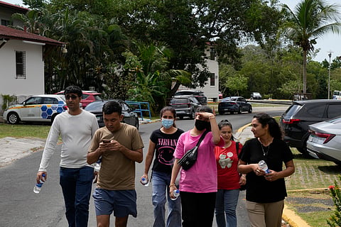 Afghan migrants deported from the US walk to the UN Refugee Agency office in Panama City, Thursday, March 20, 2025, seeking advice on how and where to seek asylum.
