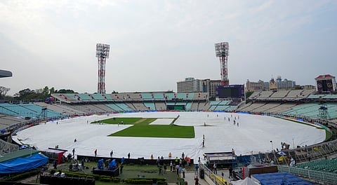 Ground staff covers the field at the Eden Gardens amid rain, ahead of an Indian Premier League (IPL) 2025 T20 cricket match between Kolkata Knight Riders and Royal Challengers Bengaluru, in Kolkata, West Bengal, Friday, March 21, 2025.
