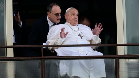 Pope Francis gestures as he appears at a window of the Agostino Gemelli Polyclinic in Rome, Sunday, March 23, 2025, where he has been treated for bronchitis and bilateral pneumonia since Feb. 14. 