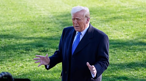 US President Donald Trump speaks with reporters before departing on Marine One en route to New Jersey, Friday, Mar. 21, 2025, in Washington. 