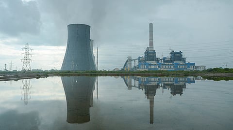 The Thoothukudi Thermal Power Plant stands tall against the cloudy sky.