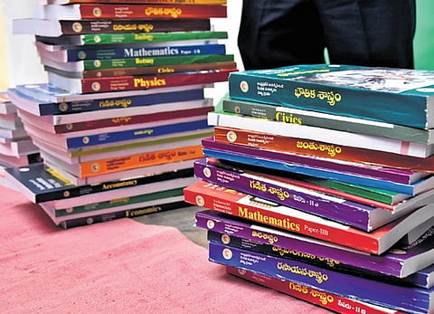 Intermediate text books after releasing it in Vijayawada on Tuesday. 