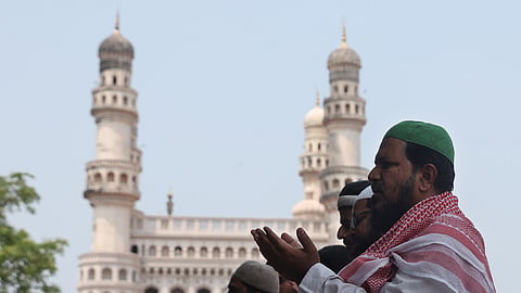 Muslims offer prayers near the Mecca Masjid in Hyderabad. 