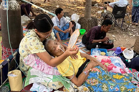 Earthquake survivors wait to receive medical attention in the compounds of a hospital in Naypyidaw on March 28, 2025, after an earthquake in central Myanmar. 