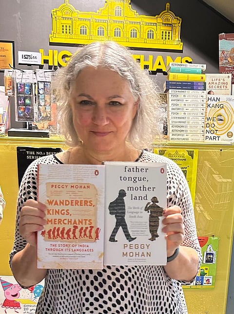Peggy Mohan with her book Father Tongue, Mother Land