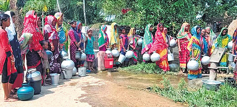 Women and kids standing in queue near a tubewell at a village in Mahakalapada 