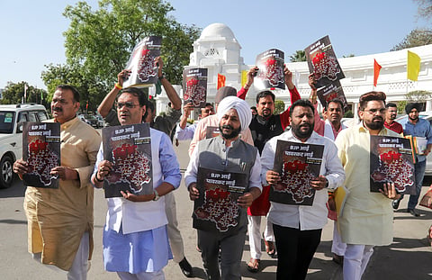 AAP MLAs stage a protest over the alleged power cuts in several areas of the national capital, during the Budget session of Delhi Assembly, in New Delhi, Tuesday, April 1, 2025. 