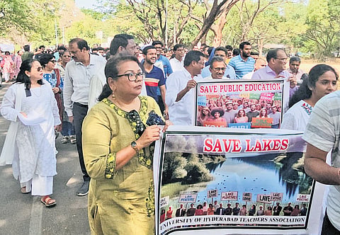Students and teachers take out a protest rally over land auction issue at the University of Hyderabad on Wednesday