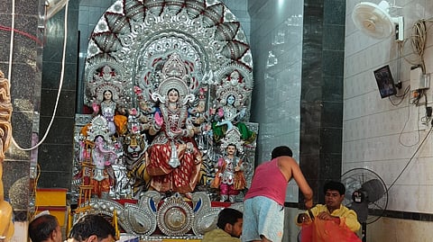 Puja organisers preparing for Sasthi Puja at Station Bazar mandap.